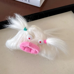 Close-up of a white plush monster hair claw clip with colorful braided pigtails