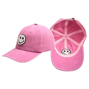 Pink washed cotton baseball cap with embroidered smiley face and adjustable back strap