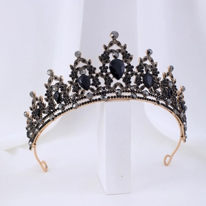 Detailed view of vintage alloy tiara with black teardrop gemstones and small gray crystals