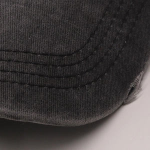 Close-up of washed cotton baseball cap brim with vintage distressed frayed details