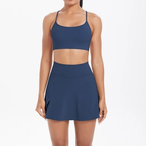 Vue détaillée de face de la brassière de sport bleu marine et de la jupe de tennis plissée