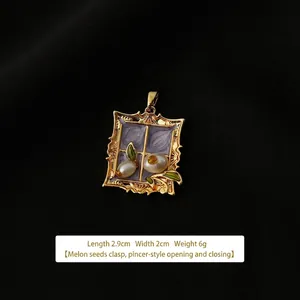 Detailed view of vintage gold pendant with purple enamel, pearls and 2.9x2cm dimensions