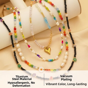 Detail of colorful seed bead necklaces with gold heart charms in vacuum plated titanium steel