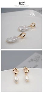 Detail view of baroque pearl drop earrings with golden irregular metal hoops and textures