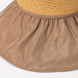 Detail of ginger straw weave and khaki fabric with pleated design on summer sun hat