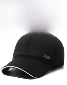 Detail of black corduroy baseball cap with metal SP Sport badge and white brim piping