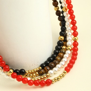 Macro detail of multi-color pearls and natural stone beads on a pearl necklace