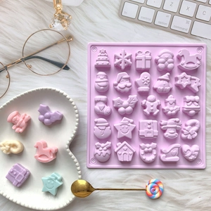 Pink silicone Christmas mold featuring 25 cavities with festive holiday shapes and patterns