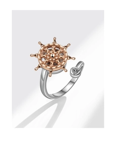 Detail of rotating rose gold nautical helm on silver ring band with knot symbol