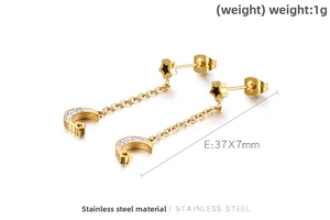 Detail of gold moon and star tassel earrings with zircon stones in stainless steel