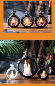 Detail of vintage Christmas lanterns with LED candles and festive Santa illustrations