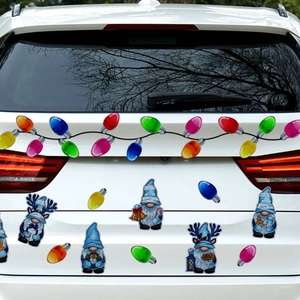 Close-up of festive Christmas gnome and colorful bulb magnetic stickers on a white car tail