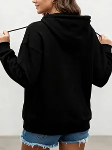 Back view of black hooded sweatshirt featuring dropped shoulders and drawstring hood