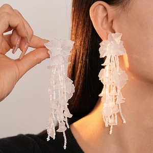 Elegant white acrylic petal tassel earrings with beads for a spring vacation look