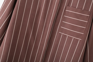 Detailed macro view of the brown striped shirt showing fabric texture and horizontal pocket