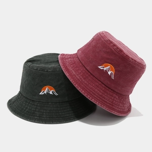 Washed canvas bucket hats with sun and mountain embroidery in dark grey and red