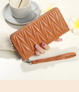 Brown quilted faux leather long clutch wallet with zip closure and wrist strap detail