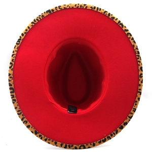 Detail view of red fedora hat with leopard print brim trim and interior sweatband