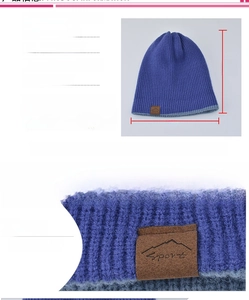 Blue knitted beanie detail showing dimensions of 28x24cm and sport leather patch