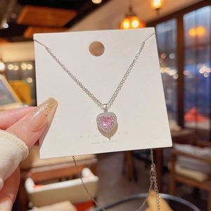 Close-up of pink heart zircon pendant with sparkling white pavé crystals on a silver chain