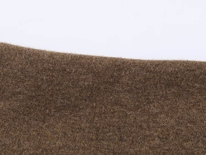 Macro shot of dark brown wool blend fabric texture showing soft fuzzy knit fibers