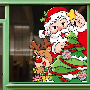 Close-up of festive Christmas window decals featuring Santa, reindeer and green tree