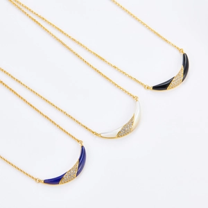 Detailed view of 925 silver 18K gold necklaces with lapis, shell and onyx crescent charms