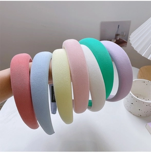 Detailed view of handmade thick padded sponge headbands in seven pastel knit colors