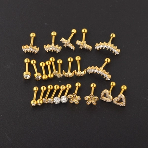 Detailed flat lay of golden cartilage earrings set with crown, moon, and flower zircon studs