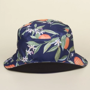 Detail of navy blue bucket hat featuring vibrant orange citrus and white flower patterns