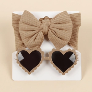 Close-up of light brown ribbed bow headband and matching heart sunglasses set