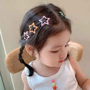 Set of colorful star hair clips and wave bobby pin worn by a cute young girl