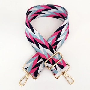 Close-up of pink and blue geometric pattern strap with adjustable gold hardware