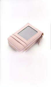 Detail view of light pink lychee texture card holder with clear ID window and zipper