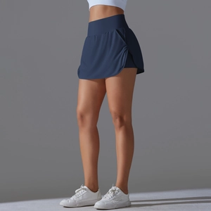 Detail view of high waisted navy blue athletic skort with side slit and built-in shorts
