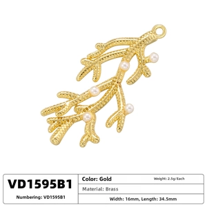 Detailed view of gold coral pendant with small white pearls and dimension markings