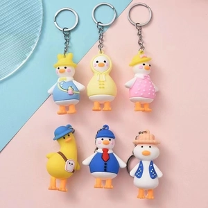 Collection of six cute cartoon duck keychains with colorful outfits and hats