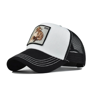 Close-up of a classic trucker hat with fox embroidery patch and black mesh back