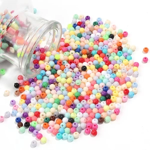 Colorful 4mm acrylic round candy beads spilling from a glass jar for DIY jewelry making
