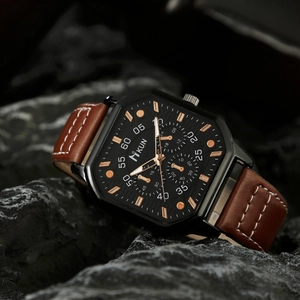 Macro detail of hexagonal men's quartz watch with black dial and brown leather strap