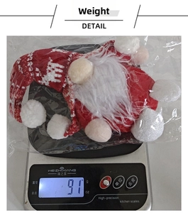 Detailed view of the 91g red and white Christmas gnome plush toy on a digital scale