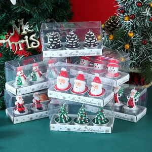 Detail view of 3-piece Christmas candle set featuring Santa, snowman, and pine tree shapes