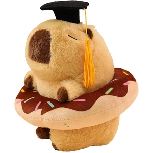 Cute capybara plush toy wearing graduation cap and doughnut ring on white background