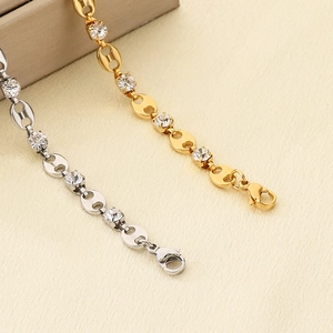 Detailed macro view of 18K gold and silver pig nose link bracelets with zircon inlay