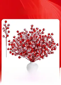 Detailed close-up of artificial red holly berries with realistic frosted snow texture