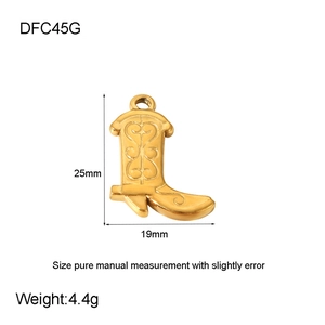 Detail of gold-plated cowboy boot charm featuring intricate floral engraving and sizing