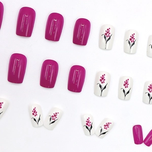 Short square press-on nails with berry magenta finish and floral leaf art patterns