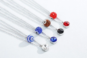 Detail of colorful crystal ball pendants on stainless steel necklaces in multiple shades
