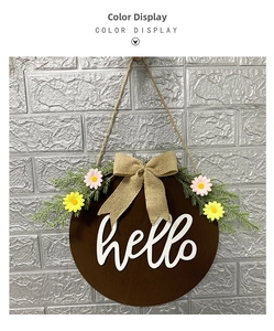 Close-up of wooden Easter welcome sign with burlap bow, greenery and small daisies