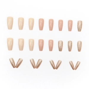Press-on nails in nude pink and oatmeal tones with champagne glitter in long ballerina shape